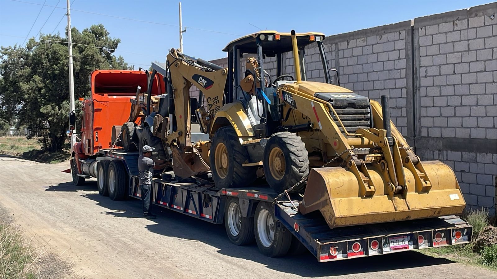 Retroexcavadora CAT asegurada sobre cama baja